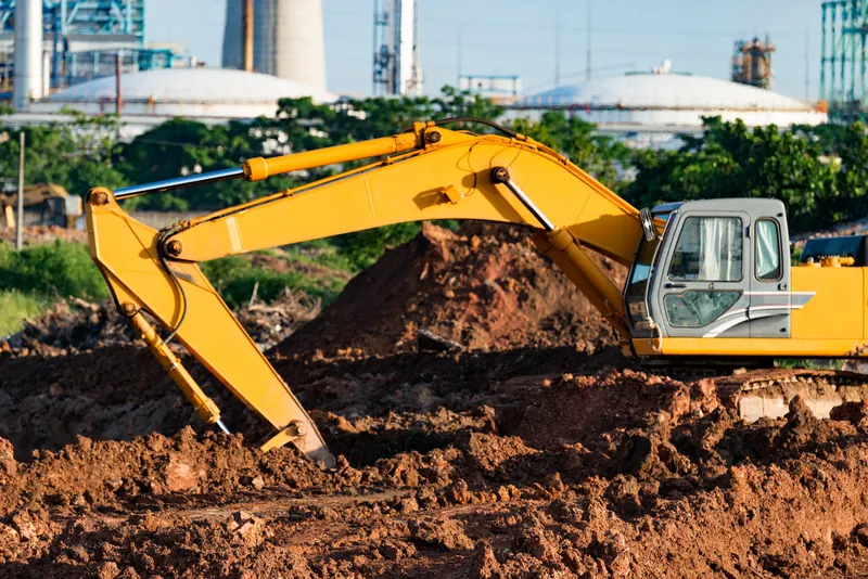 An excavator digging a trench on a construction site