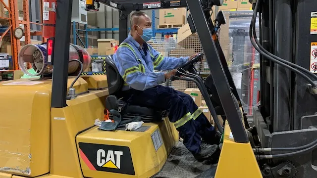 A trainee driving a counterbalance forklift at the Concord training centre