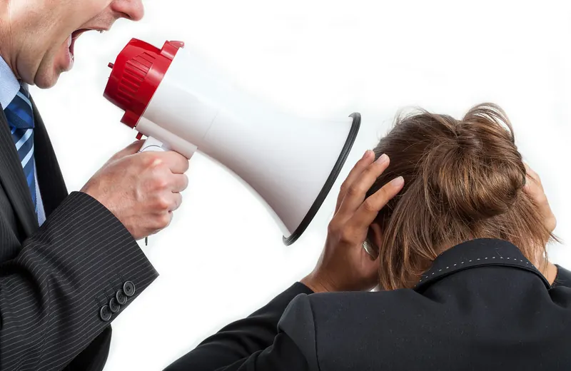 A manager shouting at an employee through a megaphone