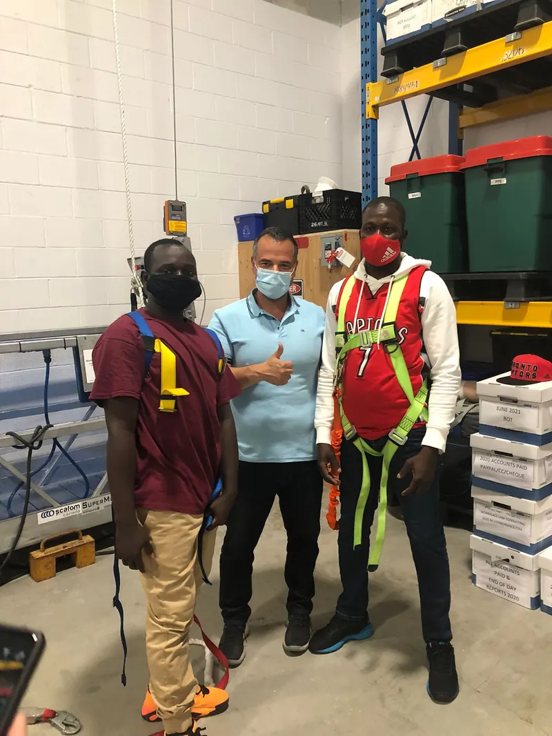 Trainees in harnesses and lanyards with their instructor in the training centre