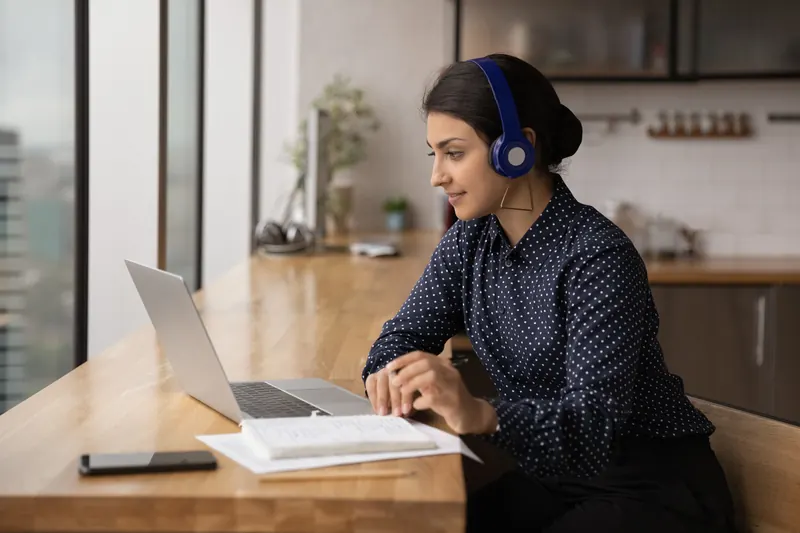 An HR professional taking a live virtual course on a laptop