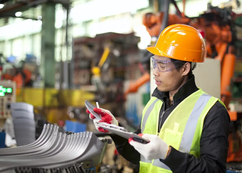 A health and safety consultant recording an inspection