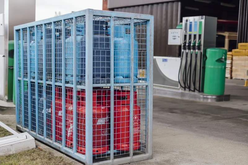 Propane cylinders stored in a locked cage