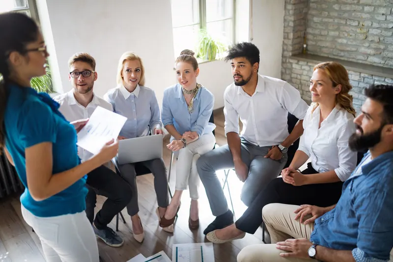 A team sitting in a circle for a discussion